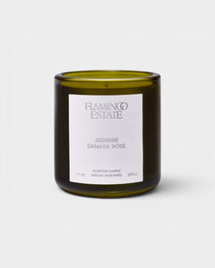 JONES + CO Night Blooming Jasmine and Damask Rose scented candle in a dark olive green glass vessel.