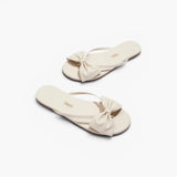 JONES + CO Lily cream leather flip flop sandals featuring an oversized bow detail and cushioned insole.