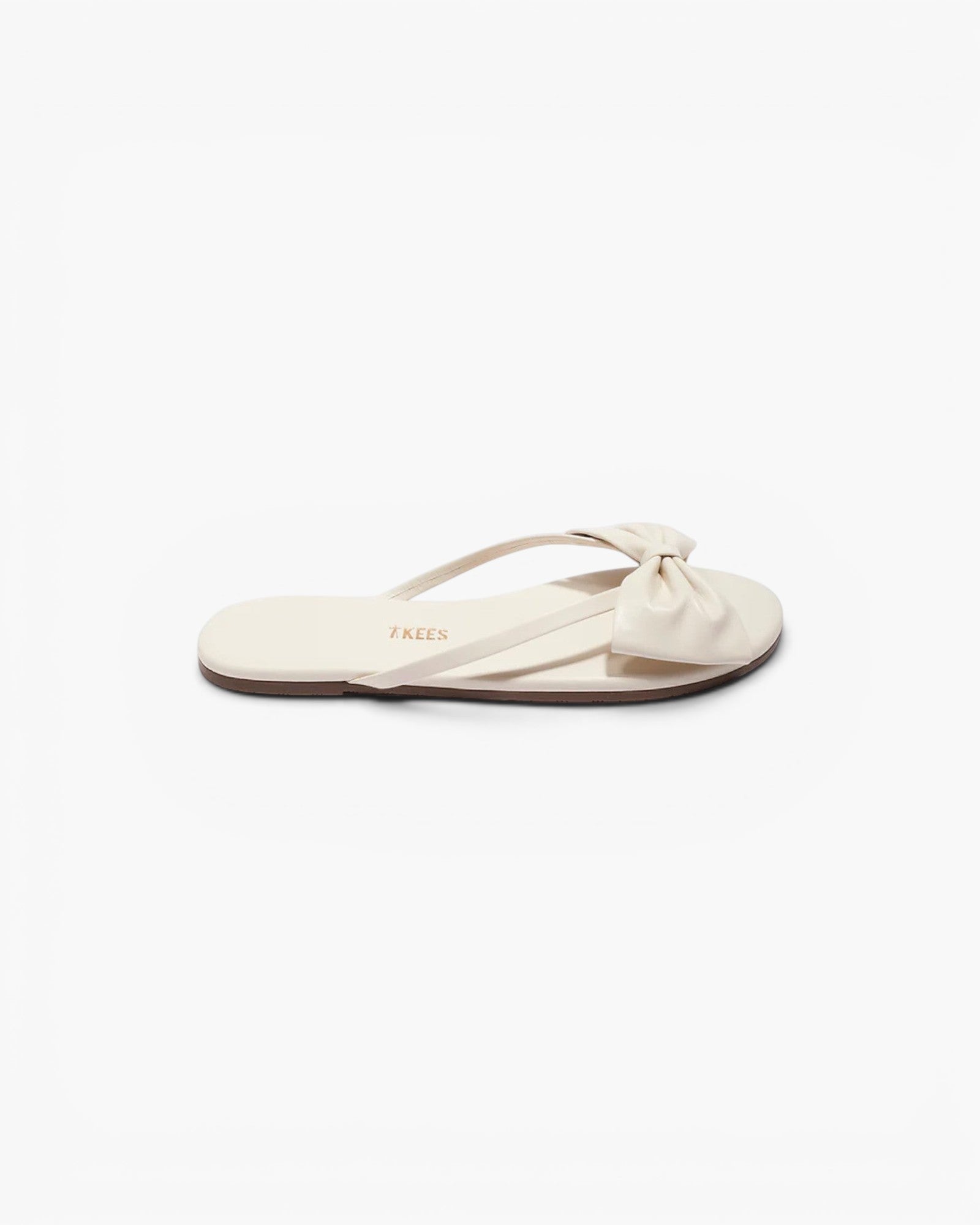 JONES + CO Lily cream leather flip flop sandal featuring an oversized bow detail and cushioned insole.
