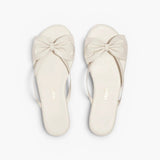 JONES + CO Lily cream leather flip flop sandals featuring an oversized bow detail and cushioned insole.