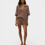 Model wearing JONES + CO Luis Polo Top in Ramona stripe knit with chevron pattern, collar, and matching shorts.