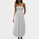 Model wearing JONES + CO light blue striped cotton strapless midi dress with shirred bodice and bubble hem.