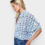 Model wearing JONES + CO organic cotton button-front shirt in indigo vine print with mandarin collar and batwing sleeves