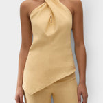 JONES + CO Maria Top in daffodil yellow linen with a halter neck, cross-front detail, and asymmetrical hemline.