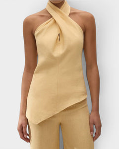 JONES + CO Maria Top in daffodil yellow linen with a halter neck, cross-front detail, and asymmetrical hemline.