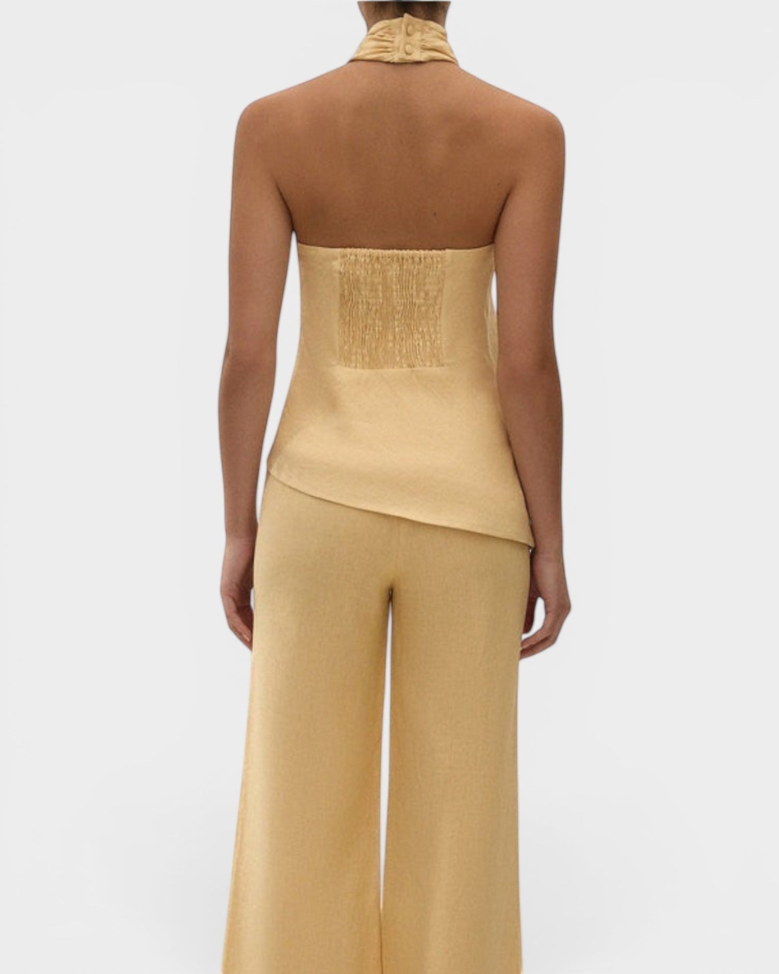 JONES + CO Maria Top in daffodil yellow linen with a halter neck, button closure, and asymmetrical hemline.