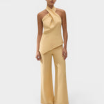 JONES + CO Maria Top in daffodil yellow linen with a halter neck and asymmetrical hem worn by a model.