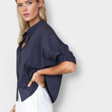 Model wearing a JONES + CO midnight blue organic cotton seersucker mandarin collar top with a relaxed, breezy fit.