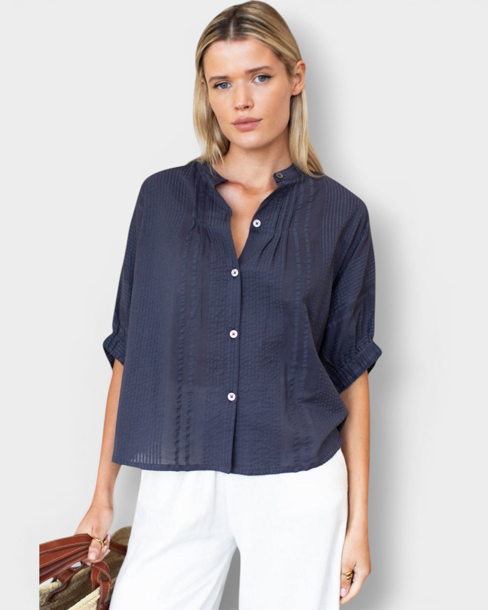 Model wearing JONES + CO midnight blue organic cotton seersucker button-front top with a mandarin collar.