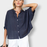 Model wearing a JONES + CO midnight blue organic cotton seersucker mandarin collar top with a relaxed, breezy fit.