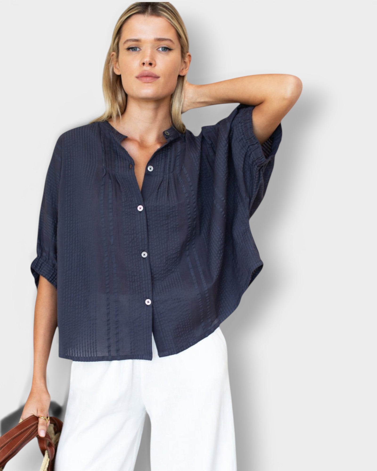 Model wearing a JONES + CO midnight blue organic cotton seersucker mandarin collar top with a relaxed, breezy fit.