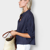 JONES + CO midnight blue organic cotton seersucker mandarin collar top with a relaxed fit worn by a blonde model.