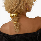 JONES + CO gold mini dome pony cuff hair accessory worn on curly blonde hair with a discreet elastic band.