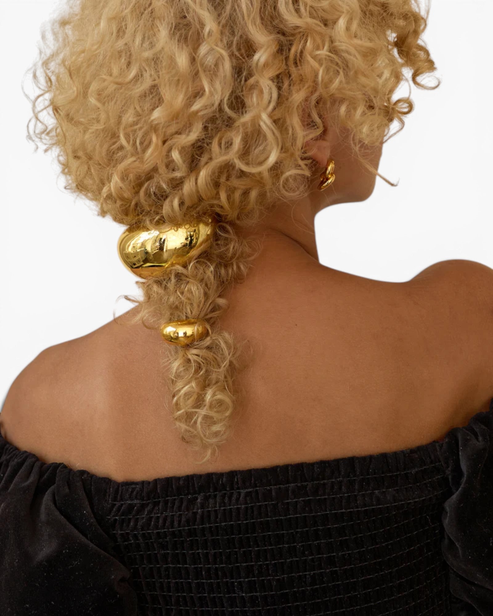 JONES + CO gold mini dome pony cuff hair accessory worn on curly blonde hair with a discreet elastic band.