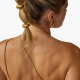 JONES + CO gold mini dome pony cuff hair accessory worn on a model's blonde hair in a bubble ponytail style.