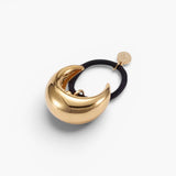JONES + CO gold mini dome pony cuff hair accessory with a black elastic band and small branded charm.