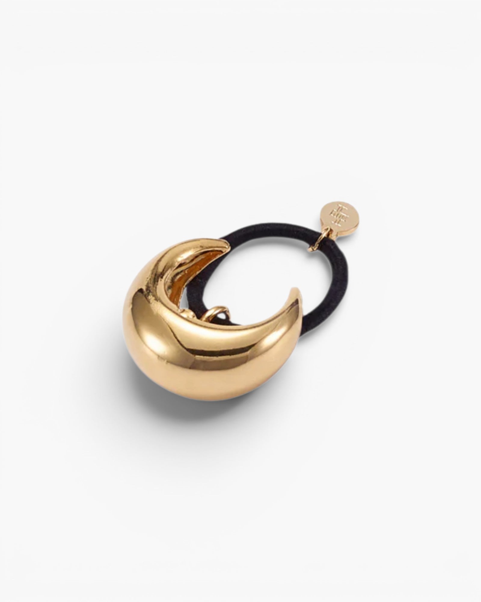 JONES + CO gold mini dome pony cuff hair accessory with a black elastic band and small branded charm.