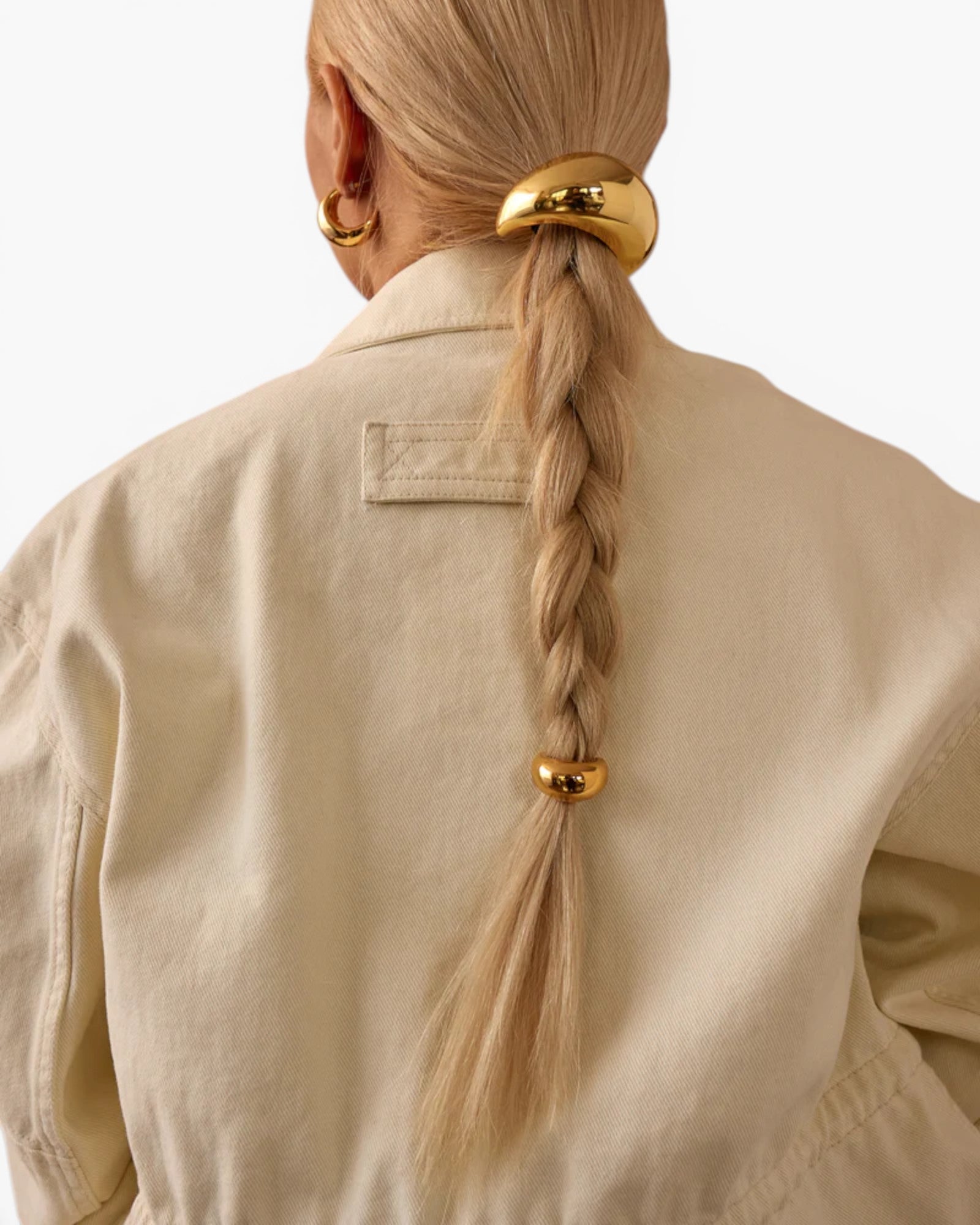 JONES + CO gold mini dome pony cuff hair accessory worn on a blonde braid with a matching glossy dome hair tie.