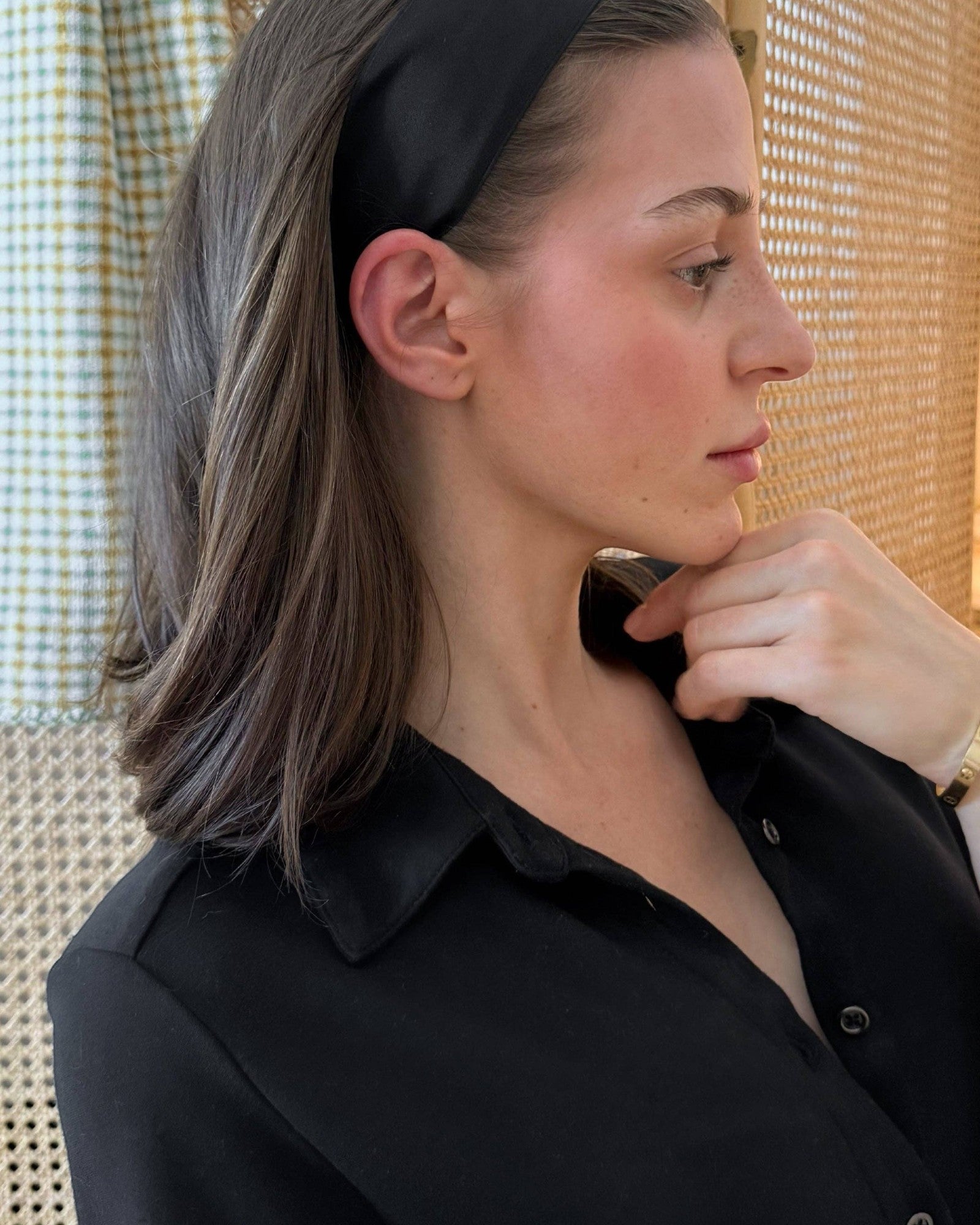 Model wearing the JONES + CO Olivia Headband in ebony black with a smooth fabric finish and comfortable fit.
