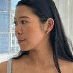 Model wearing a sleek black JONES + CO Olivia Headband with a smooth fabric finish and comfortable fit.