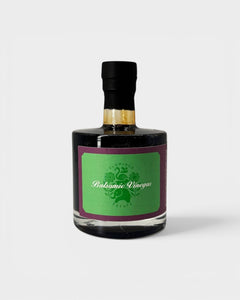 JONES + CO organic balsamic vinegar in a glass bottle with a green label, aged in oak barrels for rich flavor.