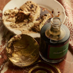 JONES + CO organic balsamic vinegar in a glass bottle, aged in oak barrels, served with gourmet food on marble.