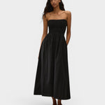 Model wearing JONES + CO black strapless midi dress in stretch-cotton with a smocked bodice and side pockets.