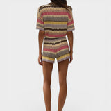 Model wearing JONES + CO Raya high-rise knit shorts in Perla multi-color stripe with a relaxed zig zag hem.
