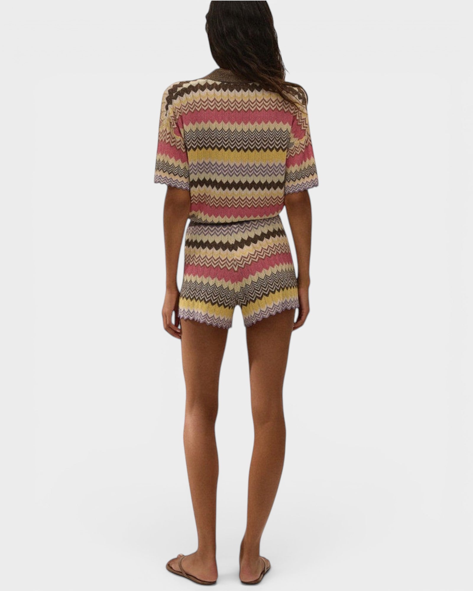 Model wearing JONES + CO Raya high-rise knit shorts in Perla multi-color stripe with a relaxed zig zag hem.
