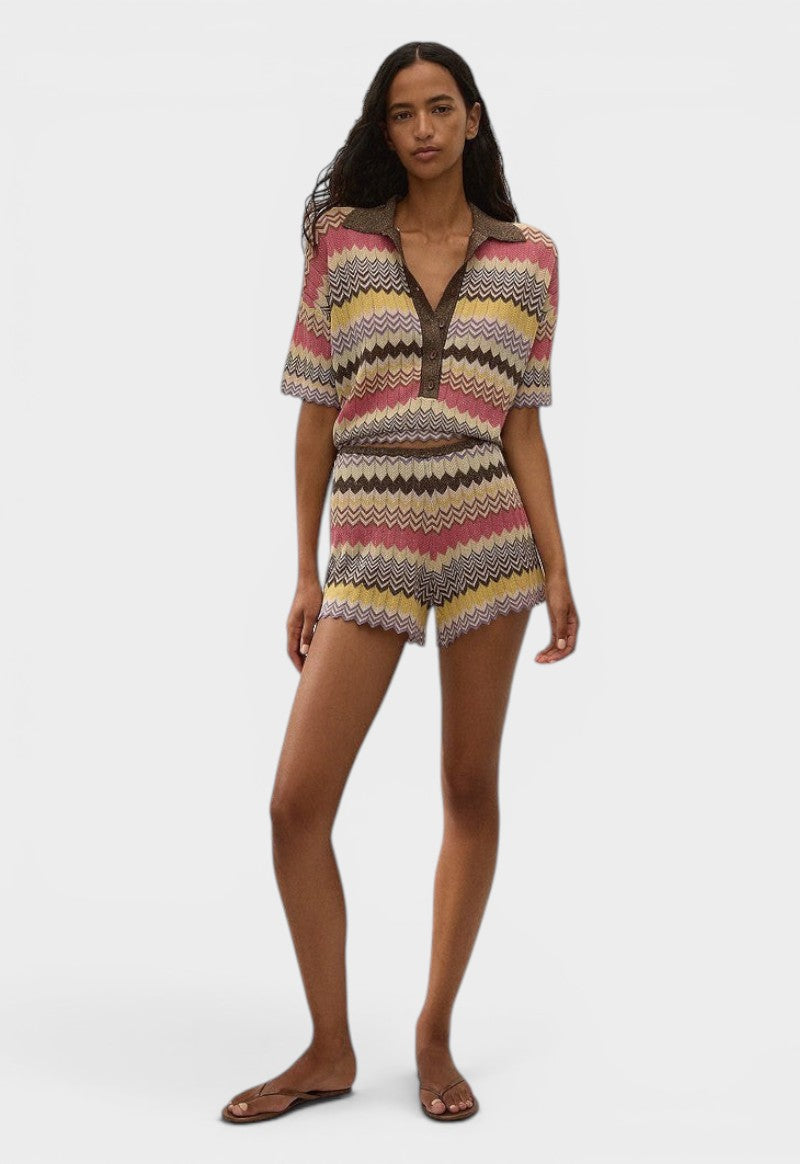 Model wearing JONES + CO Raya Polo Top in Perla multi-colour knit stripe with collar and zig zag hem.