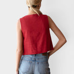 JONES + CO sleeveless linen top in pompeian red with a boxy silhouette, worn by a model with blue jeans.