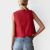 JONES + CO sleeveless linen top in pompeian red with a boxy silhouette, worn by a model with blue jeans.