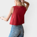 JONES + CO sleeveless boxy top in pompeian red linen worn by a model with light blue jeans.