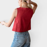 JONES + CO sleeveless boxy top in pompeian red linen worn by a model with light blue jeans.
