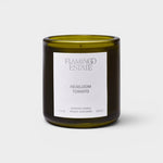JONES + CO Flamingo Estate Roma Heirloom Tomato scented candle in a dark green glass jar with a white label.