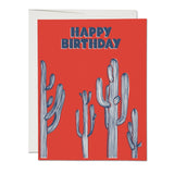 JONES + CO Saguaro Cactus Happy Birthday greeting card with blue striped illustrations on a vibrant red background.