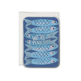 JONES + CO Sardines greeting card with blue fish illustration and We're In This Together text on recycled paper.