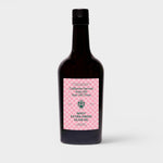 JONES + CO Spicy Extra Virgin Olive Oil in a dark glass bottle with a pink checkered label.