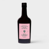 JONES + CO Spicy Extra Virgin Olive Oil in a dark glass bottle with a pink checkered label.