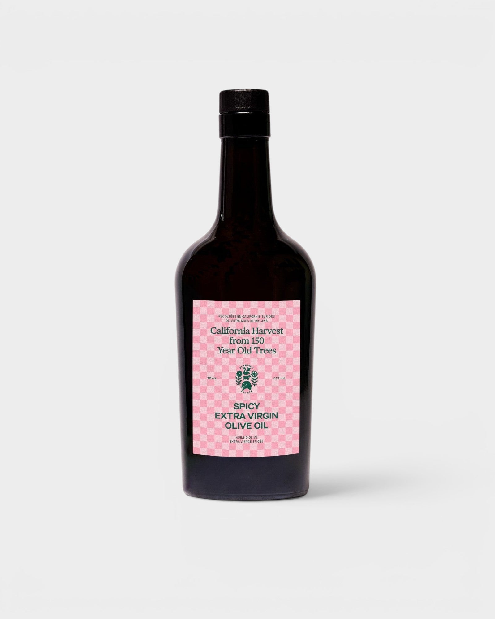 JONES + CO Spicy Extra Virgin Olive Oil in a dark glass bottle with a pink checkered label.