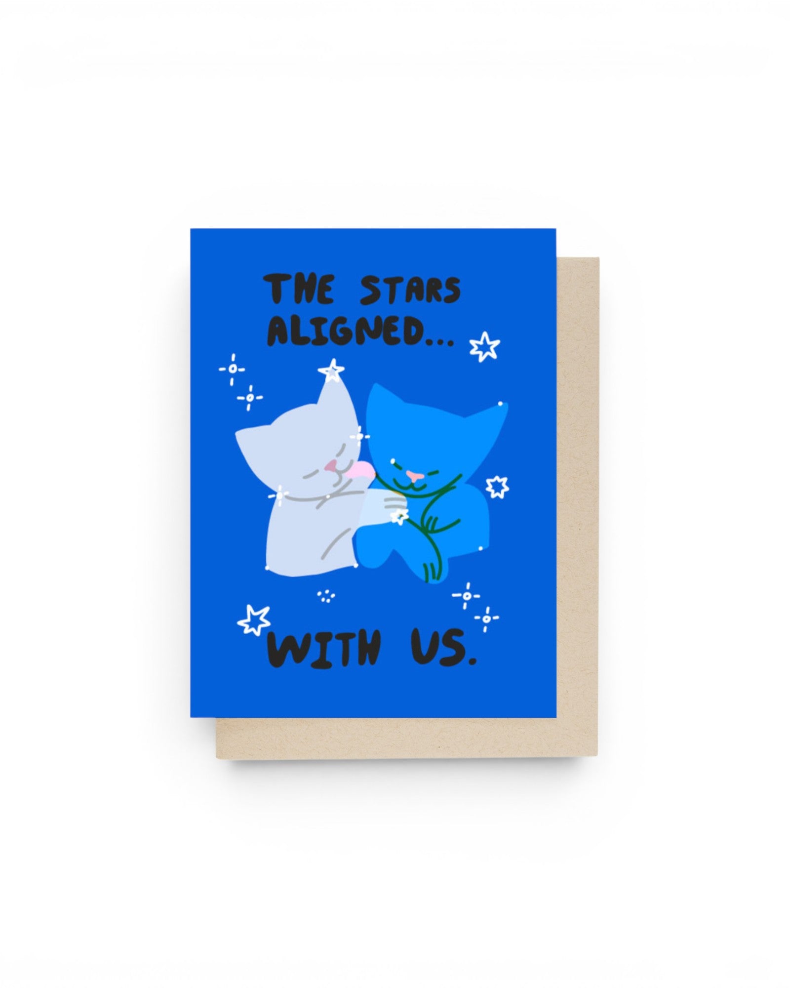 JONES + CO The Stars Aligned greeting card featuring two cute cats hugging on a blue background with star illustrations.