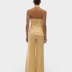Model wearing JONES + CO Syna wide-leg linen pants in daffodil yellow, featuring a high-rise fit and relaxed silhouette