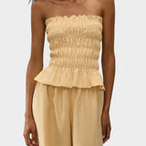 JONES + CO Tiera strapless linen top in daffodil yellow with shirred bodice, frill neckline, and peplum hem.