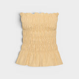 JONES + CO Tiera strapless linen top in daffodil yellow with shirred bodice, frilled neckline, and peplum hem.
