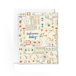 JONES + CO Welcome Baby greeting card featuring a colorful floral quilt pattern on recycled paper with an envelope.