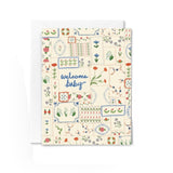 JONES + CO Welcome Baby greeting card featuring a colorful floral quilt pattern on recycled paper with an envelope.