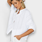 JONES + CO white organic cotton seersucker mandarin collar top with dolman sleeves on a model