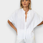 JONES + CO white organic cotton seersucker mandarin collar top with dolman sleeves on a blonde model.
