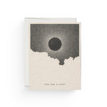JONES + CO You Are a Light greeting card with a black sun illustration by Daren Thomas Magee on recycled paper.