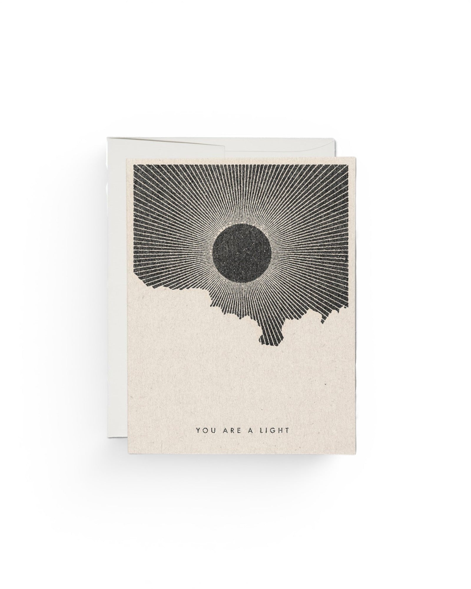 JONES + CO You Are a Light greeting card with a black sun illustration by Daren Thomas Magee on recycled paper.
